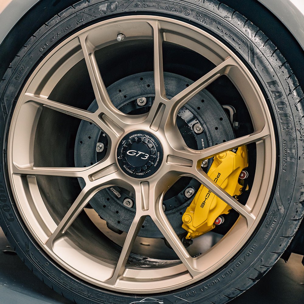 STOPFLEX carbon ceramic rotor installed on a Porsche 911 GT3 rear wheel with a standard Akebono 4-pot brake caliper.